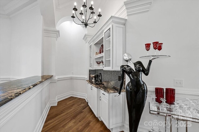 7068 Denison Rd, Summerfield, NC 27358 - indoor bar with tasteful backsplash, dark wood-style flooring, a chandelier, and ornamental molding