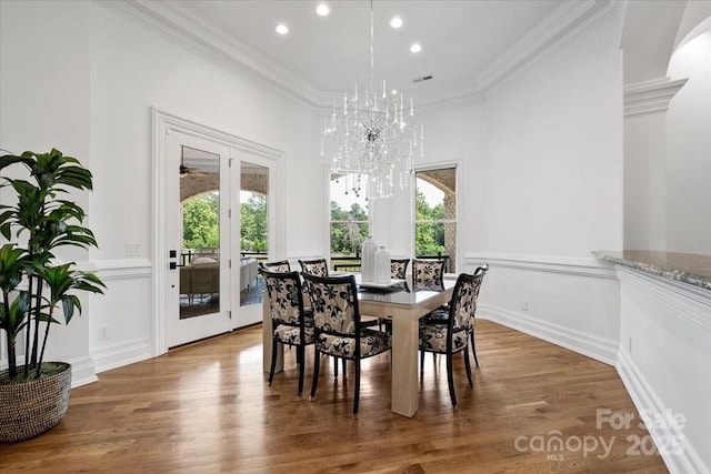 7068 Denison Rd, Summerfield, NC 27358 - dining space featuring healthy amount of natural light, recessed lighting, wood finished floors, ornamental molding, and a chandelier