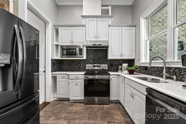7068 Denison Rd, Summerfield, NC 27358 - kitchen featuring stainless steel appliances, under cabinet range hood, light countertops, backsplash, and plenty of natural light