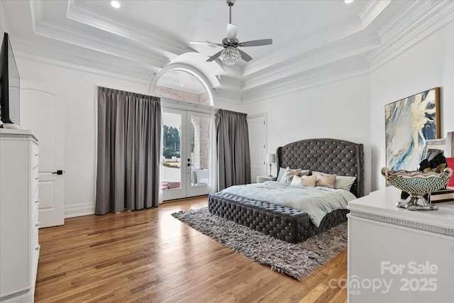 7068 Denison Rd, Summerfield, NC 27358 - bedroom with a tray ceiling, french doors, access to outside, wood finished floors, and crown molding
