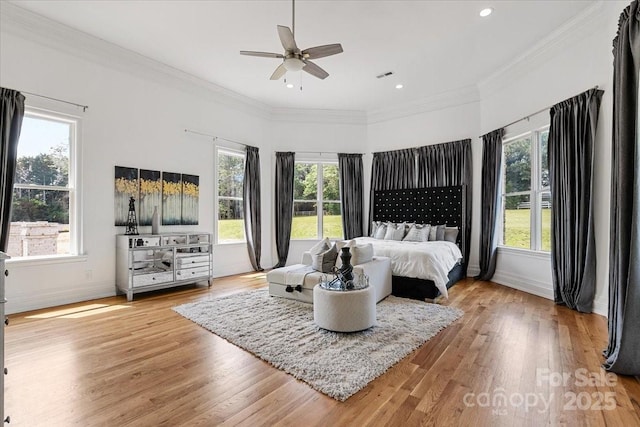 7068 Denison Rd, Summerfield, NC 27358 - bedroom with multiple windows, light wood finished floors, crown molding, and recessed lighting
