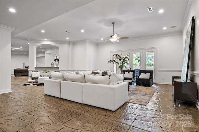 7068 Denison Rd, Summerfield, NC 27358 - living room featuring stone tile flooring, a ceiling fan, ornamental molding, arched walkways, and recessed lighting