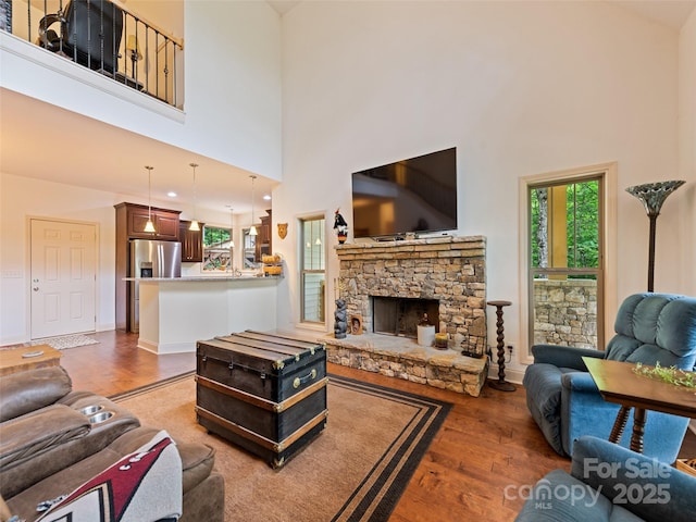 389 Manna Way, Sylva, NC 28779 - living area with wood finished floors, a high ceiling, and a fireplace