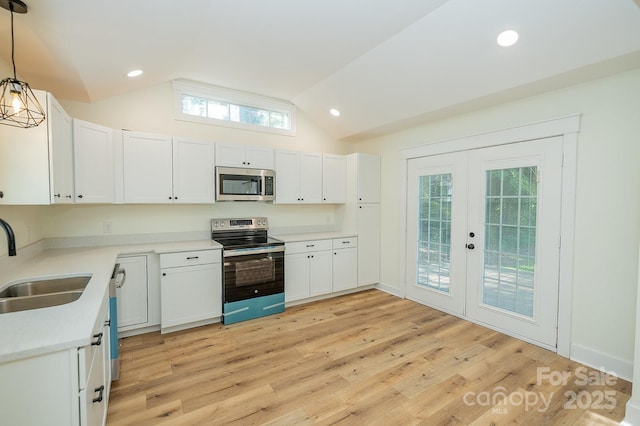 506 E Main St, Forest City, NC 28043 - kitchen featuring appliances with stainless steel finishes, vaulted ceiling, light countertops, white cabinets, and french doors