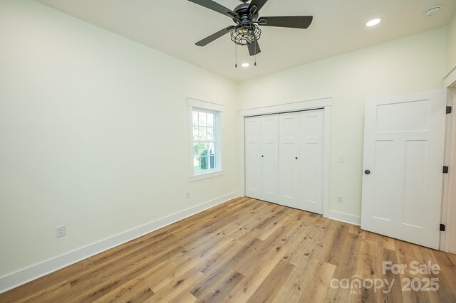 506 E Main St, Forest City, NC 28043 - unfurnished bedroom featuring light wood-style flooring, recessed lighting, a closet, and a ceiling fan