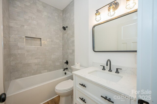 506 E Main St, Forest City, NC 28043 - bathroom featuring vanity, washtub / shower combination, and wood finished floors