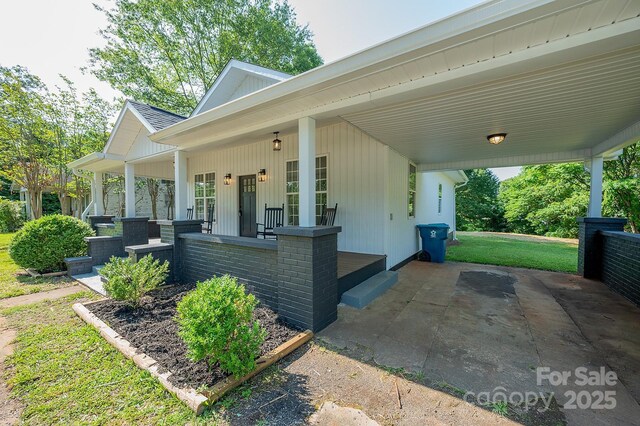 506 E Main St, Forest City, NC 28043 - view of front of house featuring covered porch, a front yard, and a carport