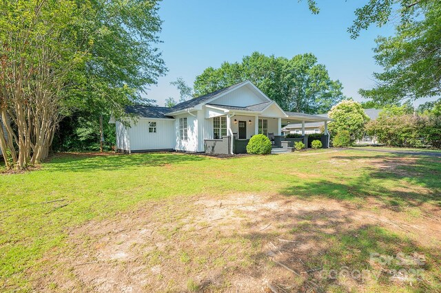 506 E Main St, Forest City, NC 28043 - rear view of property with a lawn, an attached carport, and covered porch
