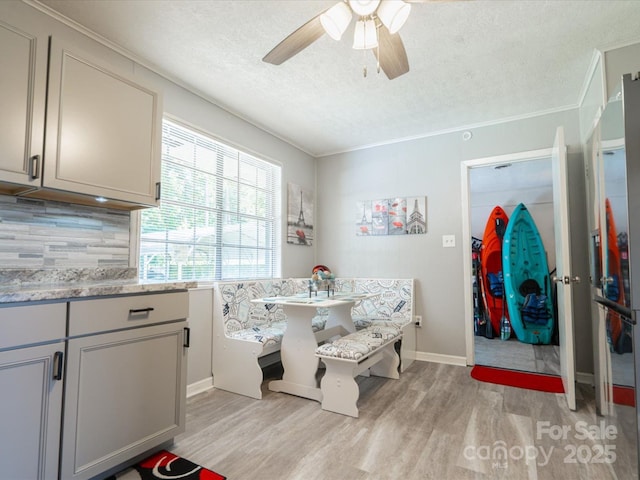 1035 Chesterfield Hwy, Cheraw, SC 29520 - dining area with light wood-style flooring, a textured ceiling, a ceiling fan, and crown molding