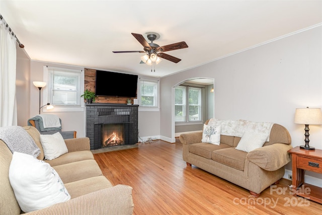 810 Maplewood Ave, Kannapolis, NC 28081 - living room featuring ornamental molding, light wood-style flooring, plenty of natural light, ceiling fan, and a brick fireplace