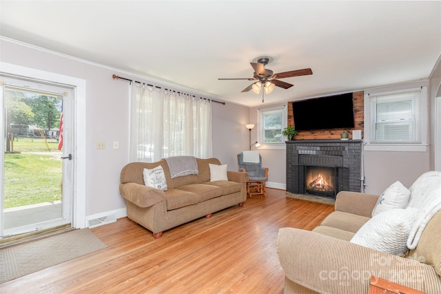 810 Maplewood Ave, Kannapolis, NC 28081 - living area featuring light wood-type flooring, a fireplace, a ceiling fan, and crown molding