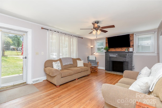 810 Maplewood Ave, Kannapolis, NC 28081 - living area featuring light wood-style floors, a brick fireplace, ceiling fan, and crown molding