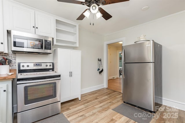 810 Maplewood Ave, Kannapolis, NC 28081 - kitchen featuring appliances with stainless steel finishes, white cabinetry, light wood finished floors, open shelves, and ornamental molding