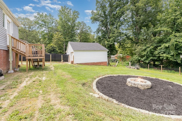 810 Maplewood Ave, Kannapolis, NC 28081 - view of yard with an outdoor fire pit, a wooden deck, stairway, an outdoor structure, and view of wooded area