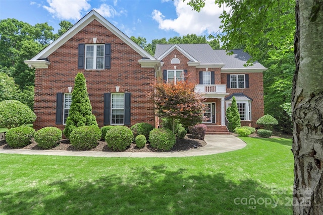 6006 Casswell Cir, Matthews, NC 28104 - colonial house featuring brick siding and a front lawn