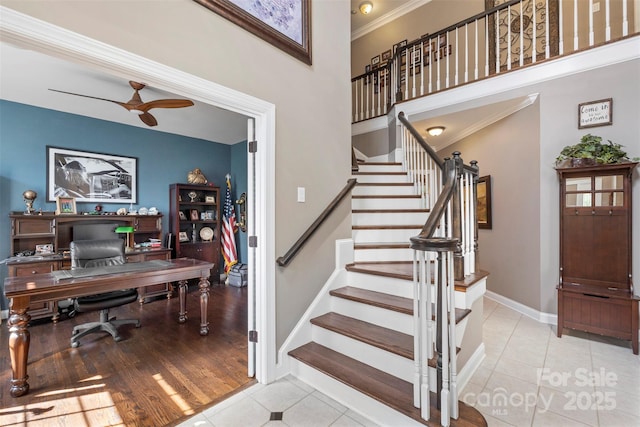 6006 Casswell Cir, Matthews, NC 28104 - staircase with crown molding, tile patterned flooring, a ceiling fan, and a towering ceiling