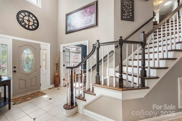6006 Casswell Cir, Matthews, NC 28104 - foyer entrance with healthy amount of natural light, tile patterned flooring, stairway, and a towering ceiling