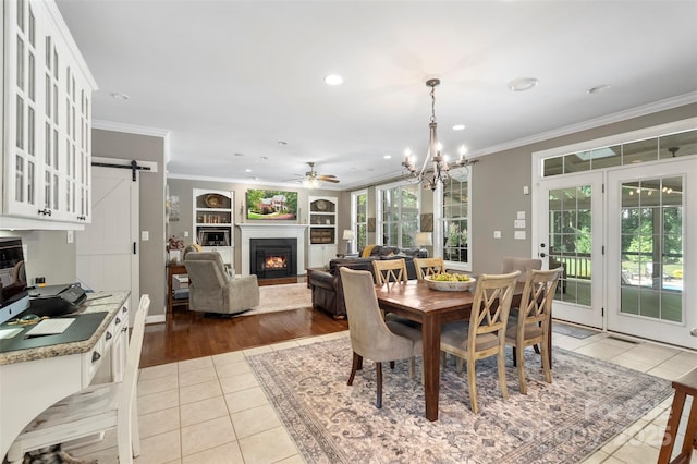 6006 Casswell Cir, Matthews, NC 28104 - tiled dining area featuring crown molding, a warm lit fireplace, a chandelier, recessed lighting, and ceiling fan