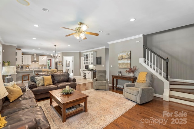 6006 Casswell Cir, Matthews, NC 28104 - living area with ceiling fan, ornamental molding, stairway, recessed lighting, and wood finished floors