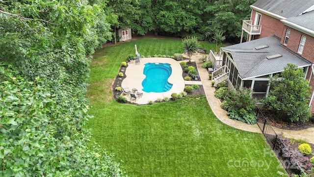 6006 Casswell Cir, Matthews, NC 28104 - outdoor pool featuring a sunroom, a lawn, and a patio
