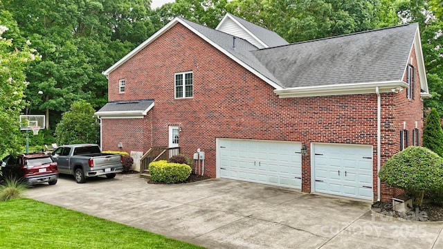 6006 Casswell Cir, Matthews, NC 28104 - view of side of home featuring a shingled roof, brick siding, driveway, and an attached garage