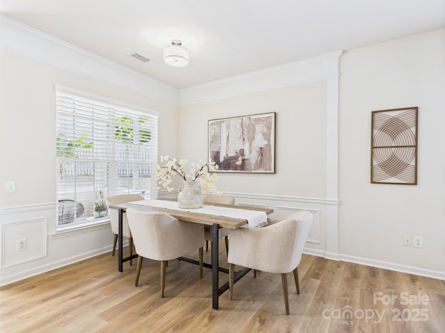 9030 Gander Dr, Charlotte, NC 28277 - dining room featuring wood finished floors, wainscoting, and a decorative wall
