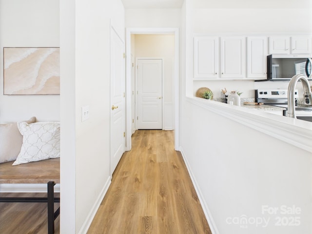 9030 Gander Dr, Charlotte, NC 28277 - hallway with light wood-style floors and baseboards