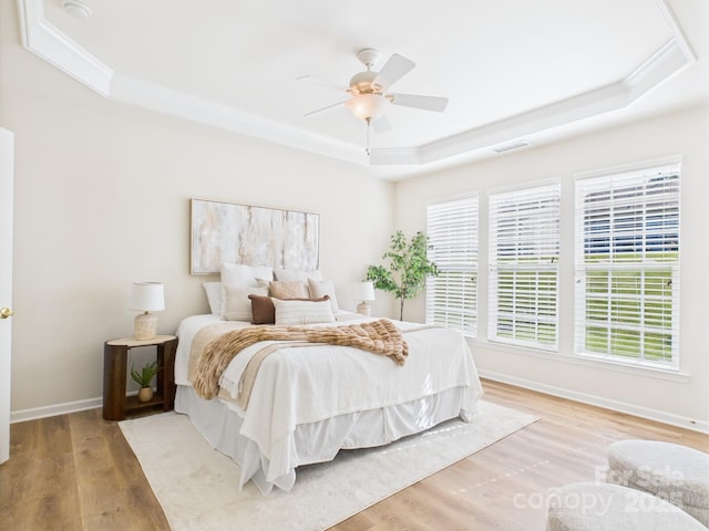 9030 Gander Dr, Charlotte, NC 28277 - bedroom with a tray ceiling, wood finished floors, ornamental molding, and a ceiling fan