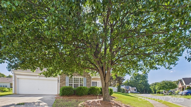 9030 Gander Dr, Charlotte, NC 28277 - obstructed view of property with concrete driveway, a garage, and stone siding