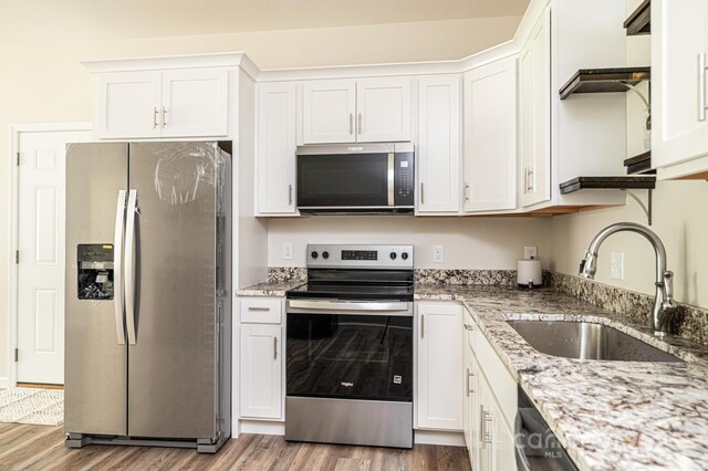 1214 Winter Pl SW, Lenoir, NC 28645 - kitchen featuring stainless steel appliances, wood finished floors, white cabinetry, and light stone countertops