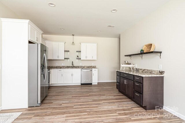 1214 Winter Pl SW, Lenoir, NC 28645 - kitchen featuring appliances with stainless steel finishes, open shelves, light wood-type flooring, white cabinetry, and recessed lighting