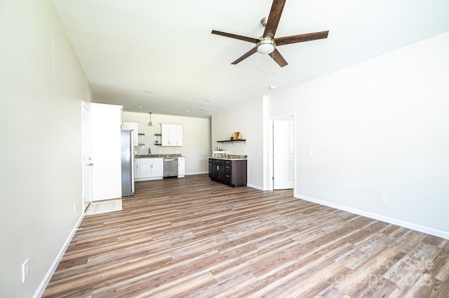 1214 Winter Pl SW, Lenoir, NC 28645 - unfurnished living room featuring ceiling fan and light wood-style flooring
