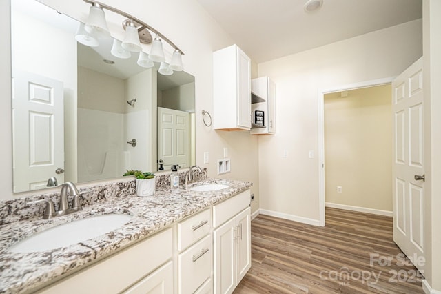 1214 Winter Pl SW, Lenoir, NC 28645 - full bath with double vanity, wood finished floors, and a shower