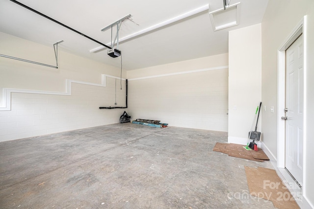 1214 Winter Pl SW, Lenoir, NC 28645 - garage featuring a garage door opener and concrete block wall