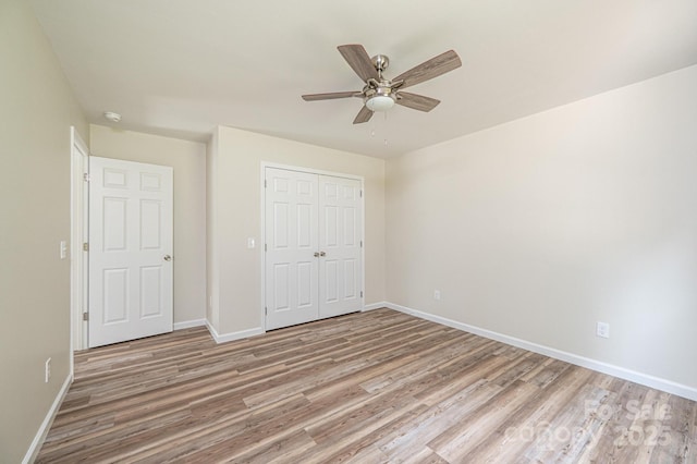 1214 Winter Pl SW, Lenoir, NC 28645 - unfurnished bedroom featuring light wood-style floors, a closet, and ceiling fan