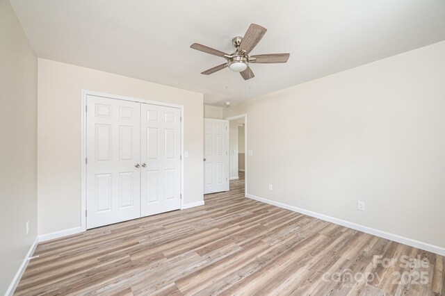 1214 Winter Pl SW, Lenoir, NC 28645 - unfurnished bedroom with light wood-style floors, a closet, and ceiling fan