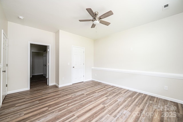 1214 Winter Pl SW, Lenoir, NC 28645 - unfurnished bedroom with wood finished floors, a closet, and a ceiling fan