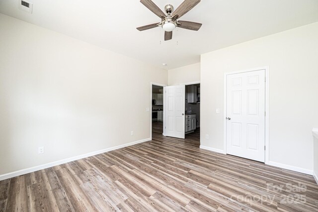 1214 Winter Pl SW, Lenoir, NC 28645 - unfurnished bedroom featuring wood finished floors and ceiling fan