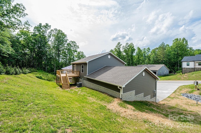 1214 Winter Pl SW, Lenoir, NC 28645 - view of home's exterior with stairway, a deck, a yard, and roof with shingles