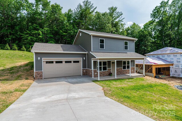 1214 Winter Pl SW, Lenoir, NC 28645 - traditional-style house featuring a garage, concrete driveway, a porch, stone siding, and a front lawn