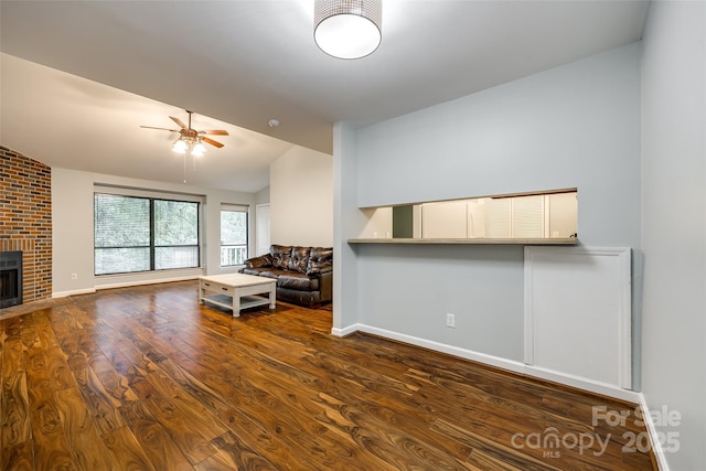 1606 Sharon Rd W Unit 40, Charlotte, NC 28210 - living room featuring vaulted ceiling, ceiling fan, a fireplace, and wood finished floors