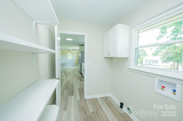 1696 Race Path Church Rd, Mooresboro, NC 28114 - laundry room with hookup for a washing machine, cabinet space, and light wood finished floors