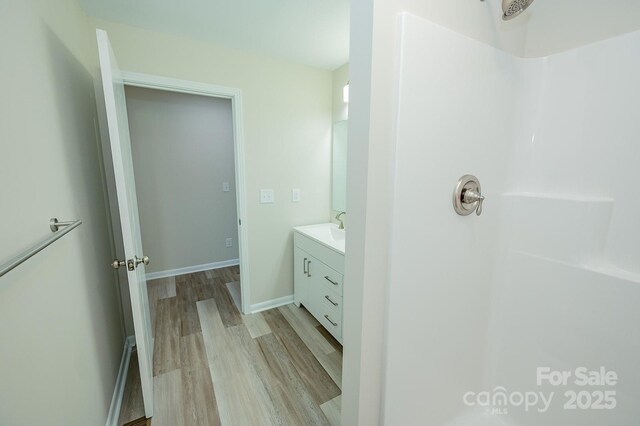 1696 Race Path Church Rd, Mooresboro, NC 28114 - full bathroom with wood finished floors, vanity, and a shower