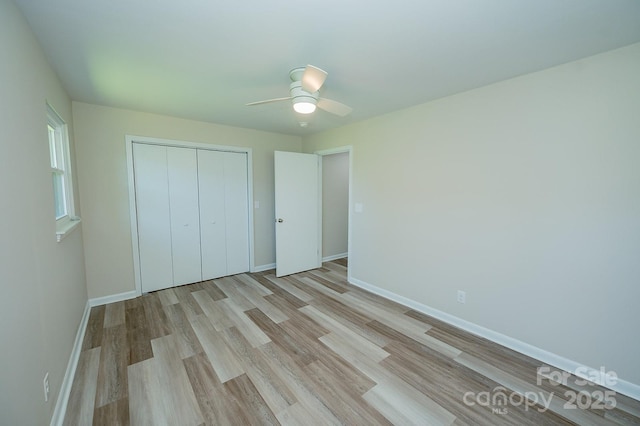 1696 Race Path Church Rd, Mooresboro, NC 28114 - unfurnished bedroom featuring light wood-style floors, a closet, and ceiling fan