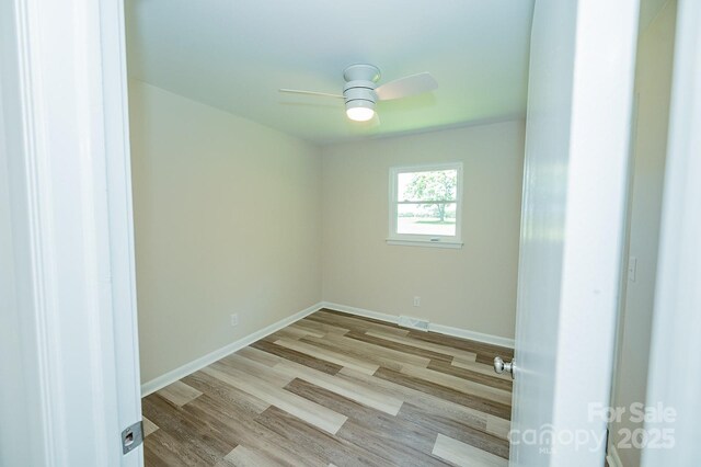 1696 Race Path Church Rd, Mooresboro, NC 28114 - empty room with a ceiling fan and wood finished floors