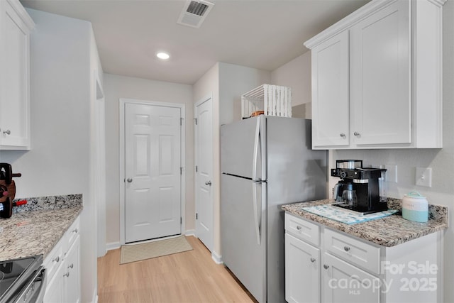 410 Apex Cir, Shelby, NC 28152 - kitchen with stainless steel appliances, light wood-type flooring, white cabinets, and recessed lighting