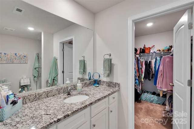 410 Apex Cir, Shelby, NC 28152 - bathroom with vanity, a spacious closet, and recessed lighting