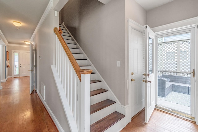 2619 Merion Hills Ct, Charlotte, NC 28269 - foyer entrance featuring light wood finished floors, stairway, and crown molding