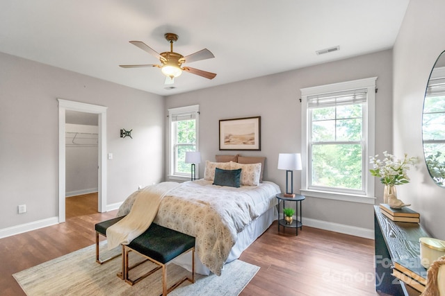 2619 Merion Hills Ct, Charlotte, NC 28269 - bedroom featuring wood finished floors, a walk in closet, and ceiling fan