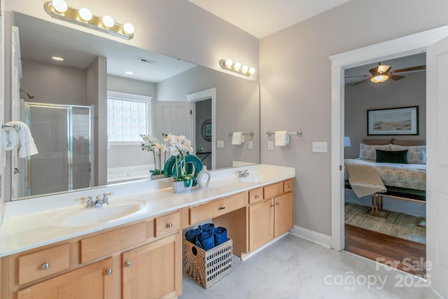 2619 Merion Hills Ct, Charlotte, NC 28269 - ensuite bathroom featuring double vanity, a stall shower, a garden tub, ceiling fan, and marble look tiles